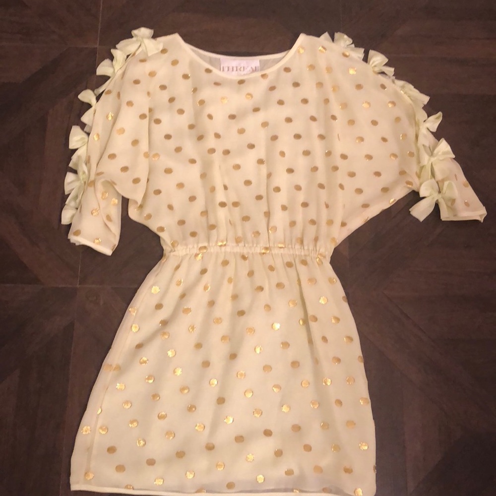Yellow and gold polka dot mini dress with bows.